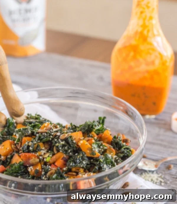 Vegan Christmas Delights: 50 Festive Plant-Based Meals 10 Kale and squash salad in a glass bowl with dressing in the background.