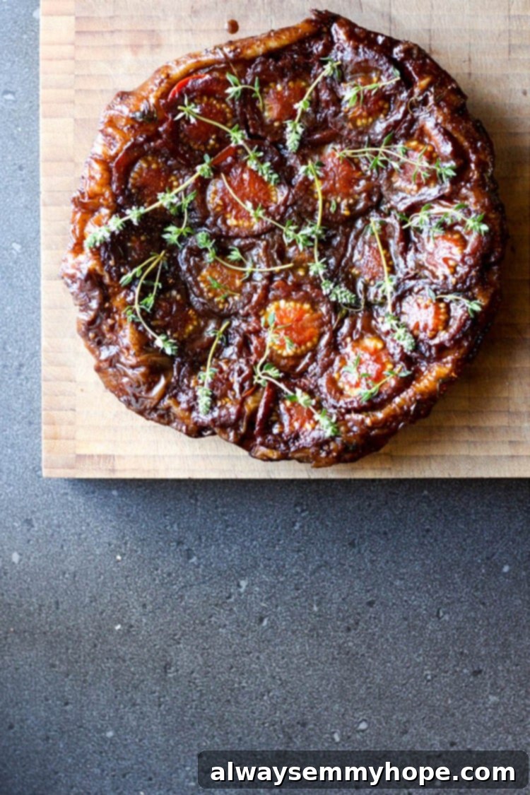 Vegan Christmas Delights: 50 Festive Plant-Based Meals 11 Top down shot of a tomato tart tatin on a wooden chopping board.