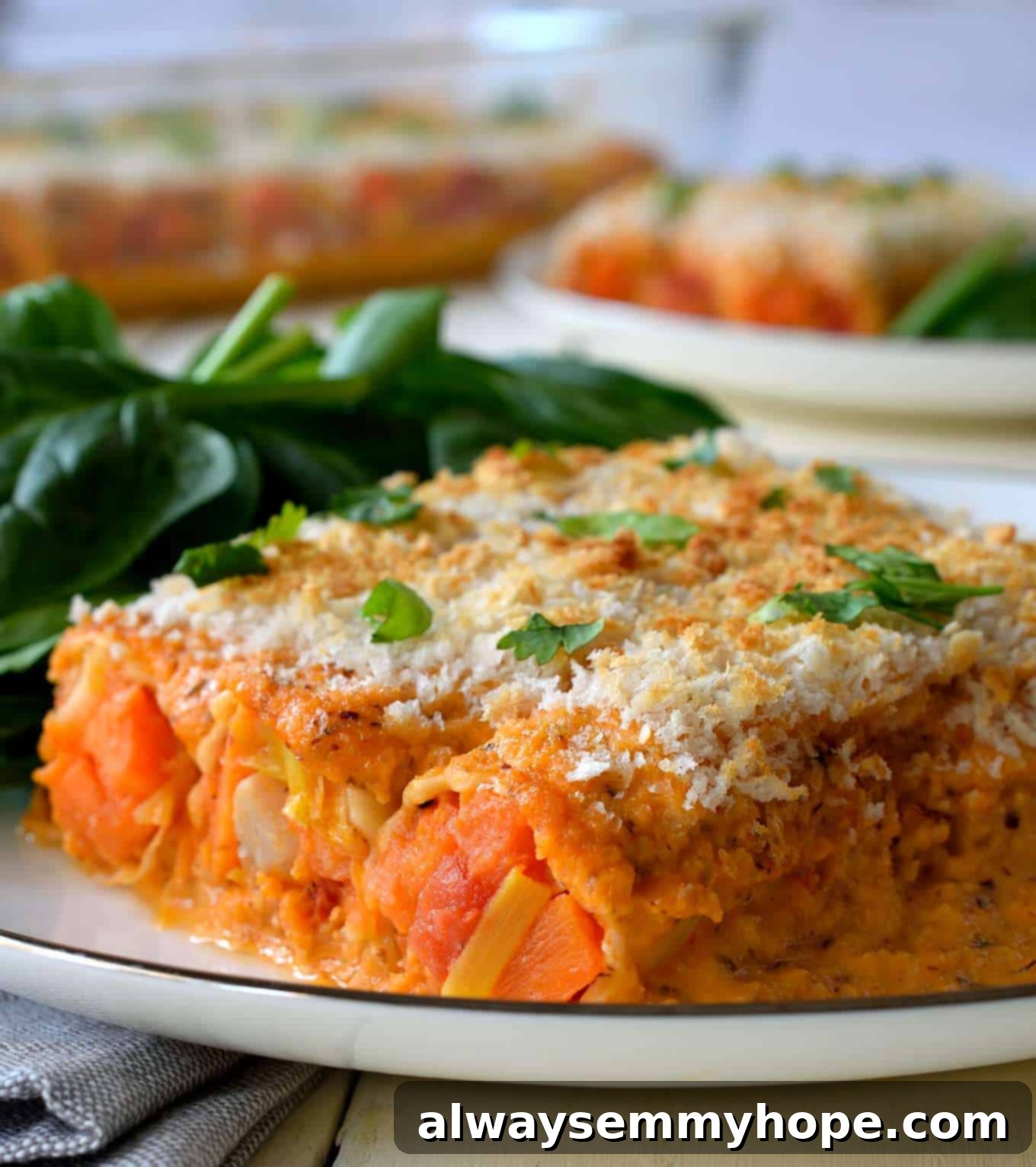 Vegan Christmas Delights: 50 Festive Plant-Based Meals 12 Side on shot of vegan cannelloni with spinach on the side.