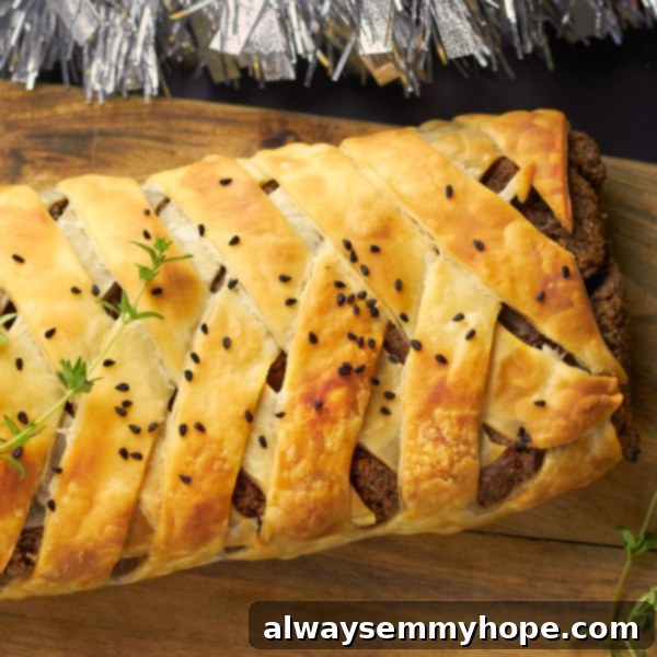 Vegan Christmas Delights: 50 Festive Plant-Based Meals 15 Top down shot of pecan and mushroom wellington on a wooden chopping board.