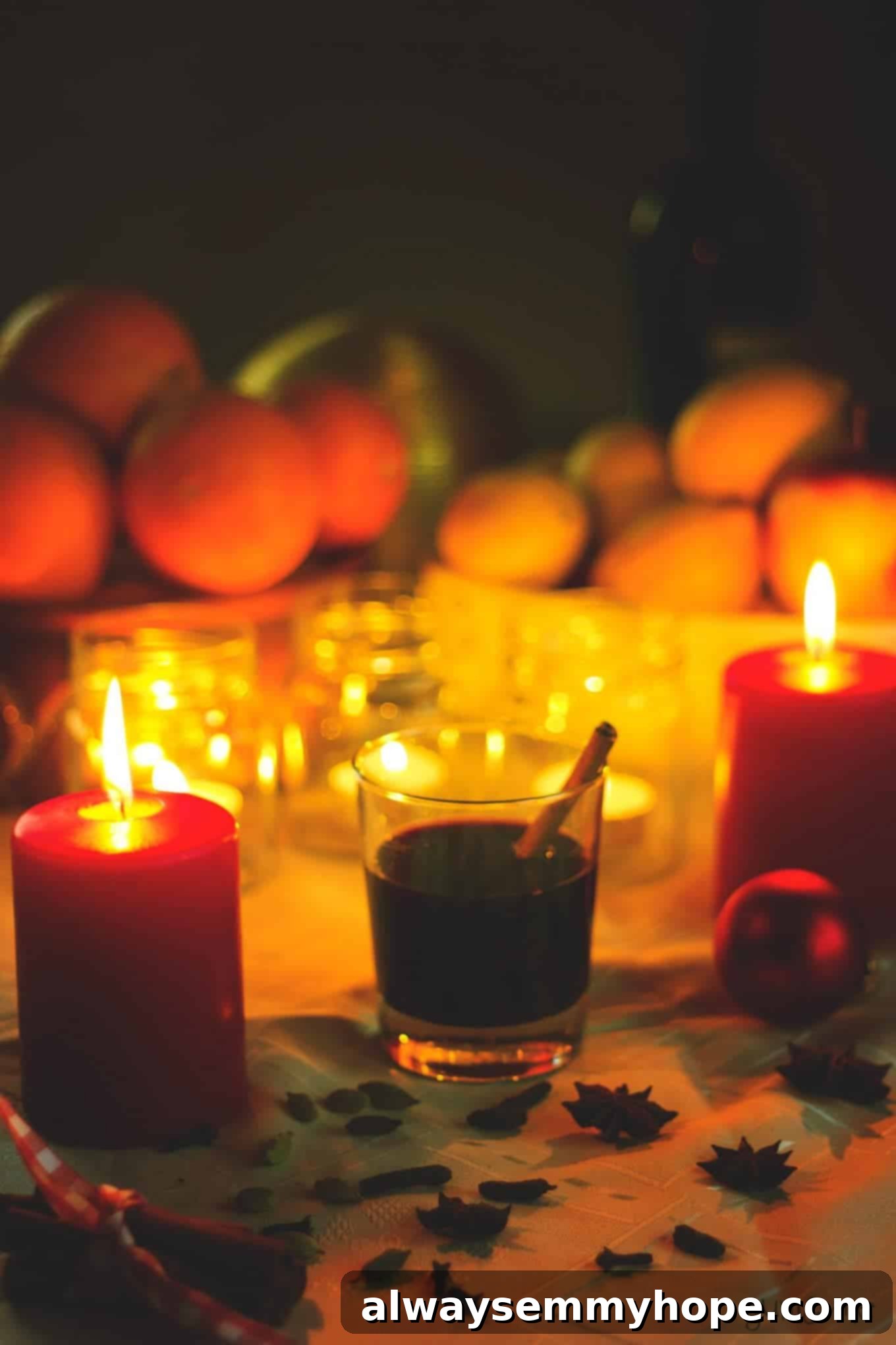 Vegan Christmas Delights: 50 Festive Plant-Based Meals 21 A glass of mulled wine surrounded by candles.