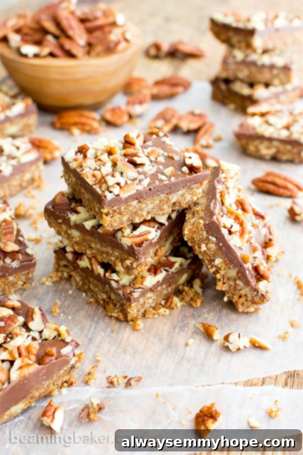 Vegan Christmas Delights: 50 Festive Plant-Based Meals 25 A stack of paleo pecan bars surrounded by pecans.