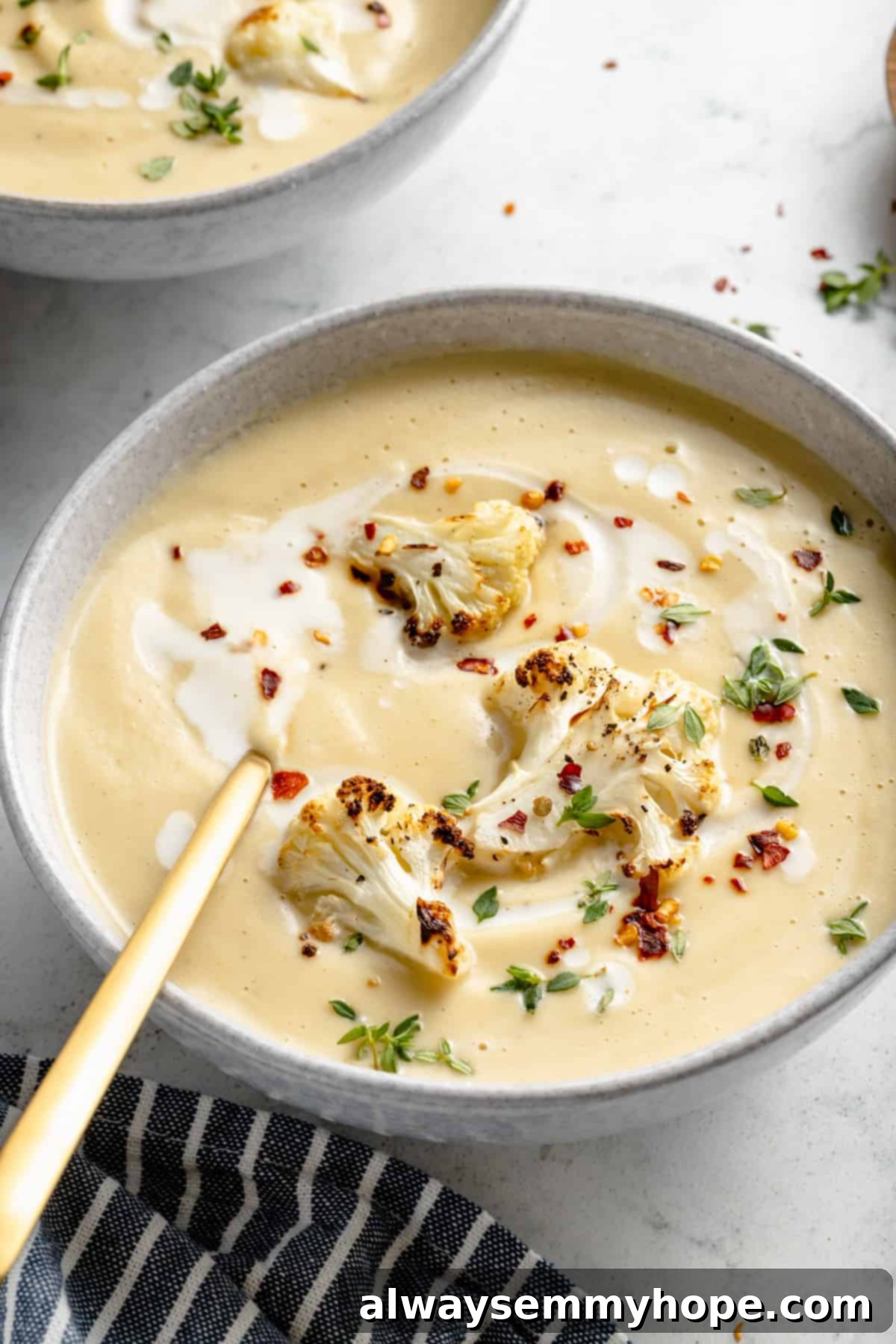 Velvety Roasted Cauliflower Soup 12 Roasted cauliflower soup in bowl with gold spoon