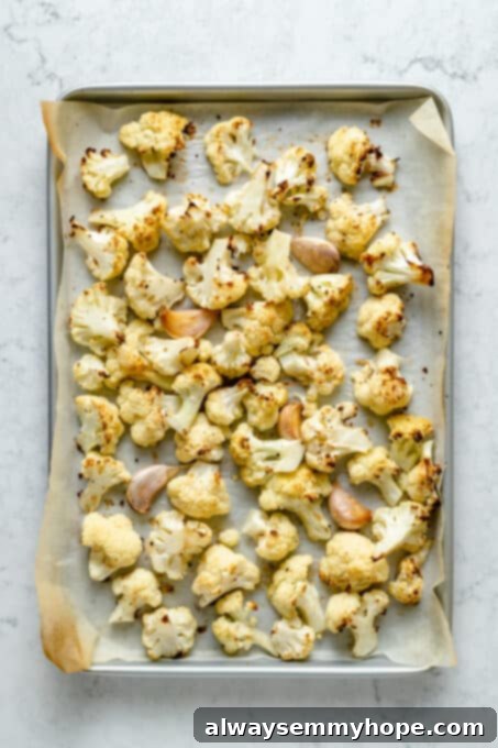 Velvety Roasted Cauliflower Soup 5 Roasted cauliflower on parchment-lined baking sheet