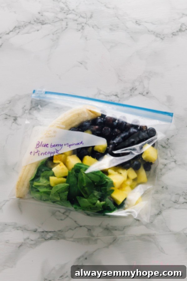 7 Simple and Speedy Vegan Banana Smoothies 7 Assorted colorful fruits and greens portioned into a freezer-safe ziplock bag, ready for smoothie meal prep.