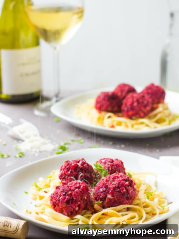Chickpea and beet balls on a bed of pasta. 