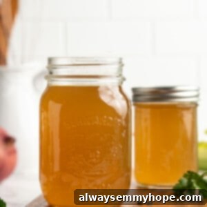 Zero-Waste Vegetable Broth from Kitchen Scraps 2 Two jars of homemade vegetable broth on wood cutting board