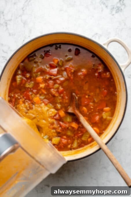 Pouring pureed soup back into pot