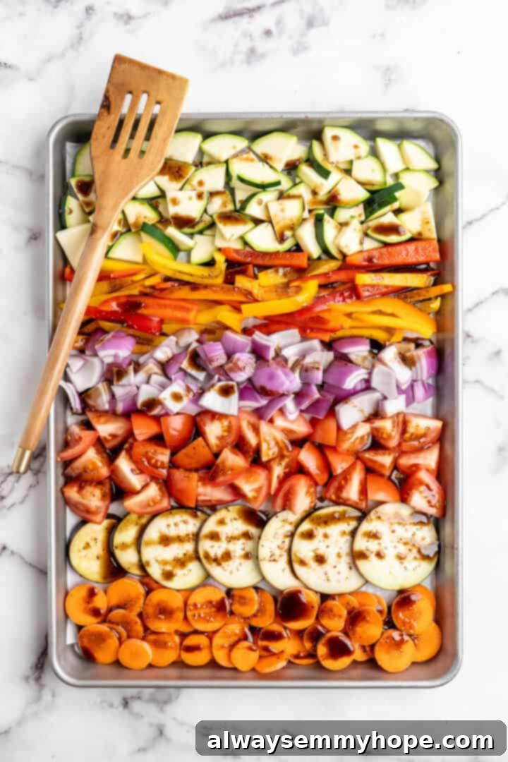 Easy Balsamic Roasted Vegetables 6 Freshly chopped vegetables on a baking sheet, generously drizzled with the savory balsamic marinade, anticipating a delicious transformation in the oven.