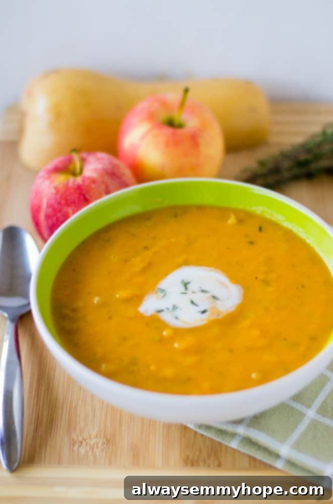 A green bowl full of apple and butternut squash soup. 