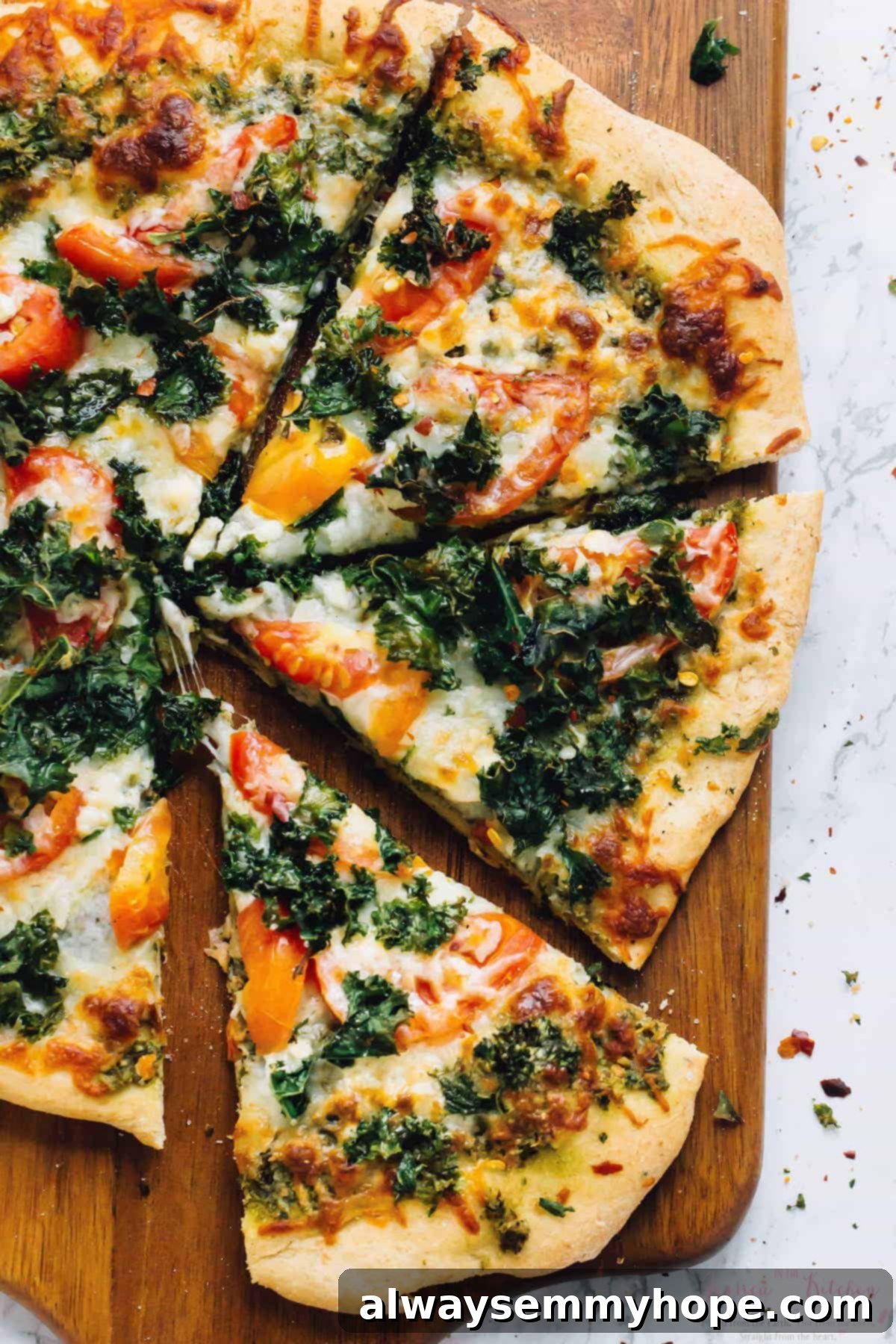 Overhead view of sliced kale pizza