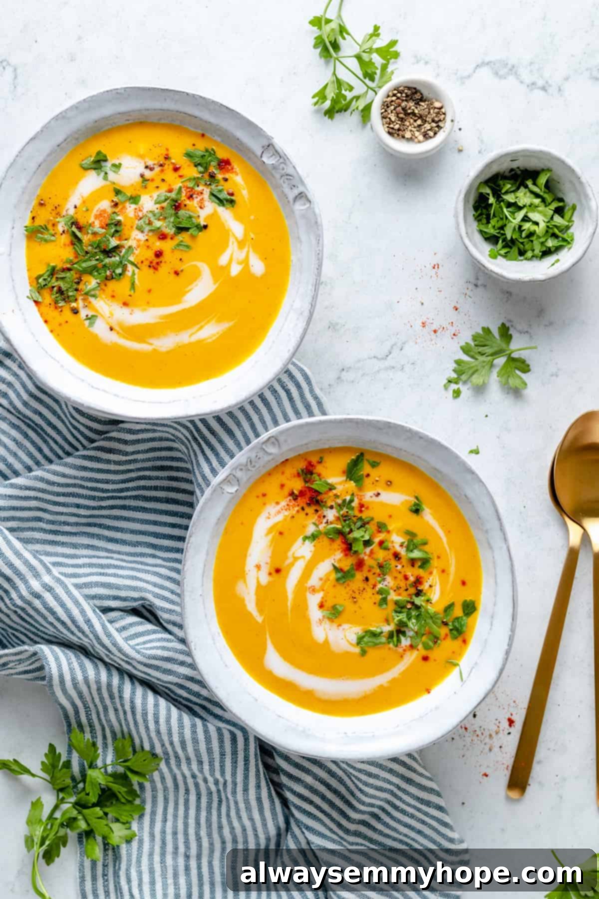 Golden Roasted Carrot Ginger Soup 10 Overhead view of two bowls of roasted carrot soup swirled with coconut milk