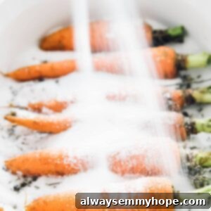 The Alchemy of Salt Roasted Carrots 10 Some carrots being covered with salt in a baking dish.