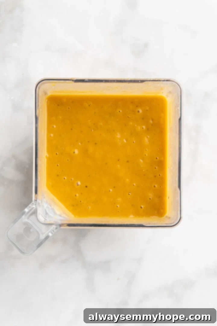 Blending Butternut Squash Soup Overhead view of pureed butternut squash soup in a high-speed blender, showing its creamy texture