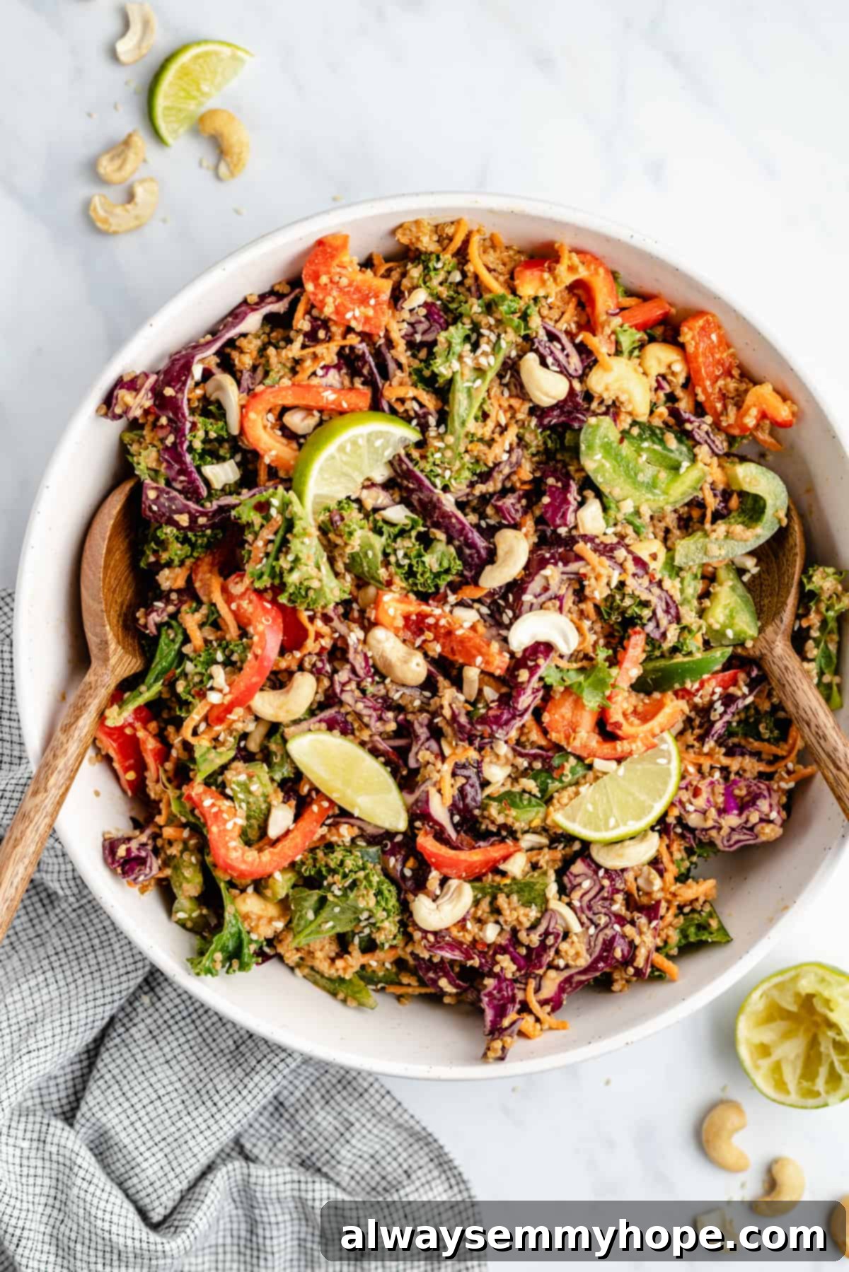 Discover the best 15-minute Thai quinoa salad, a vibrant vegan meal packed with flavor and a divine peanut ginger sauce, perfect for any time of day. Vibrant overhead view of a large serving bowl filled with Thai quinoa salad, garnished with fresh cilantro and chopped peanuts, alongside salad tongs.