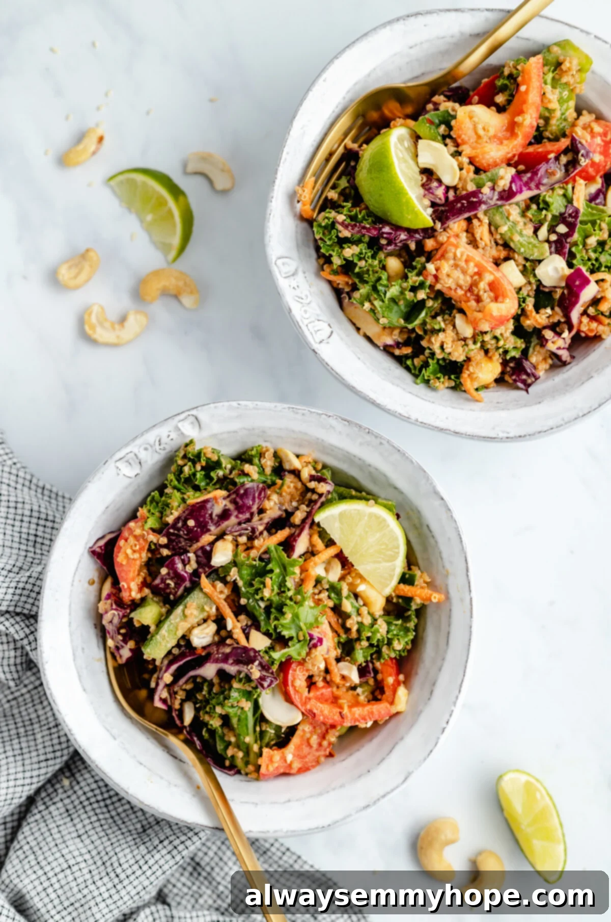 Enjoy individual servings of this delightful Thai quinoa salad, a perfect healthy and flavorful vegan meal for any time. Two individual serving bowls filled with fresh Thai quinoa salad, garnished with cilantro and cashews, with forks ready to enjoy.