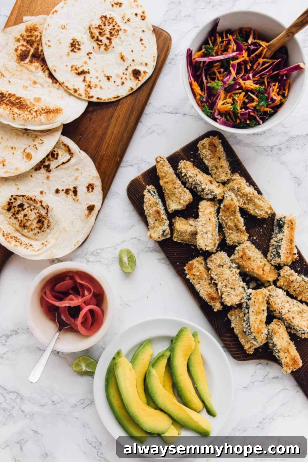 Overhead view of the individual components for crispy zucchini tacos, meticulously arranged: golden zucchini spears, colorful cabbage slaw, sliced avocado, and soft tortillas.