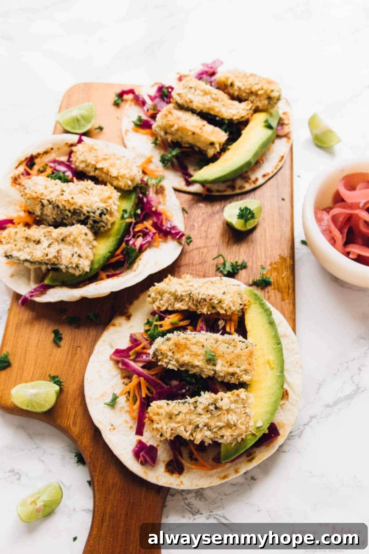 Three perfectly assembled crispy zucchini tacos presented on a wooden board, ready to be enjoyed.