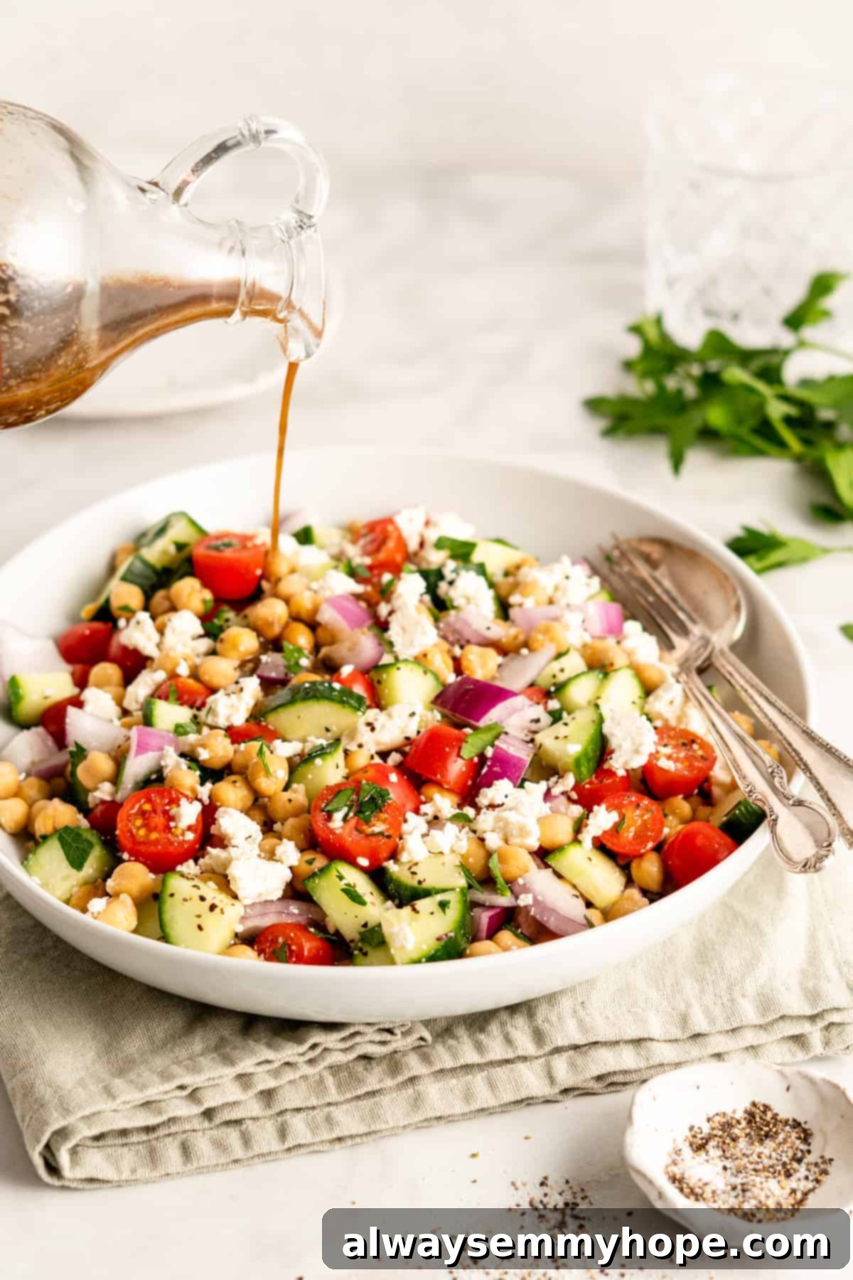 Zesty Mediterranean Chickpea Salad 5 Balsamic vinaigrette poured onto chickpea salad.