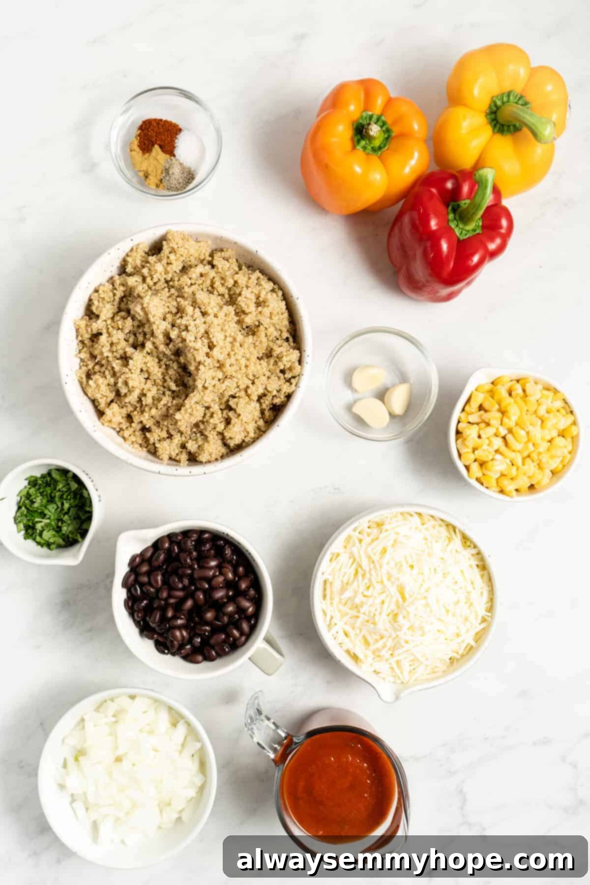 A vibrant selection of fresh ingredients for making vegan stuffed peppers laid out on a surface.