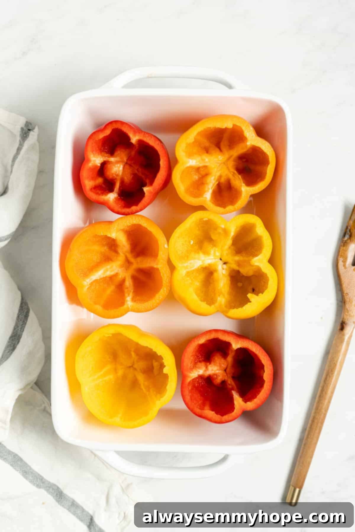 Scooped-out bell peppers arranged neatly in a baking dish, ready for stuffing.