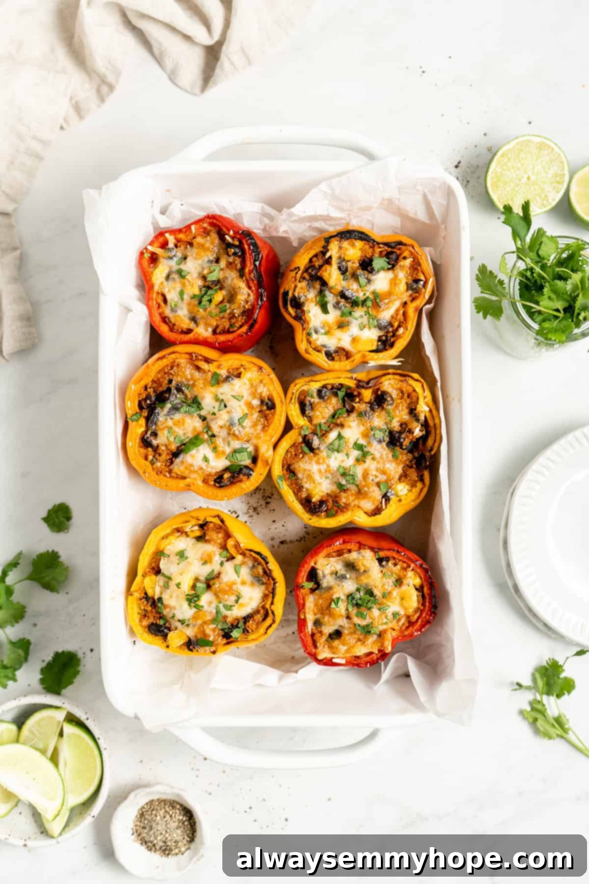 Six beautifully baked vegan stuffed peppers arranged in a baking pan, golden and inviting.