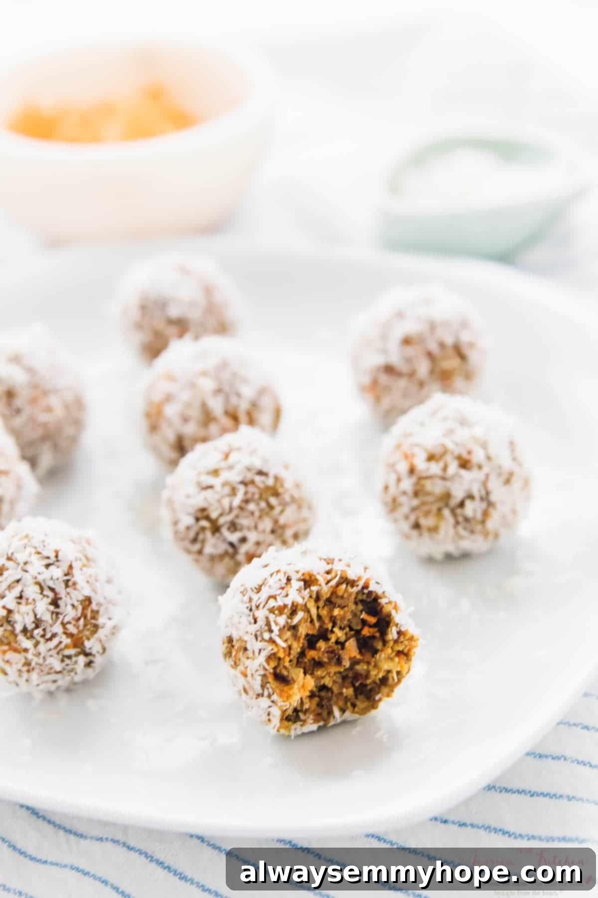 Quick Vegan No Bake Carrot Cake Energy Bites 4 A plate of carrot cake energy bites on a striped cloth.