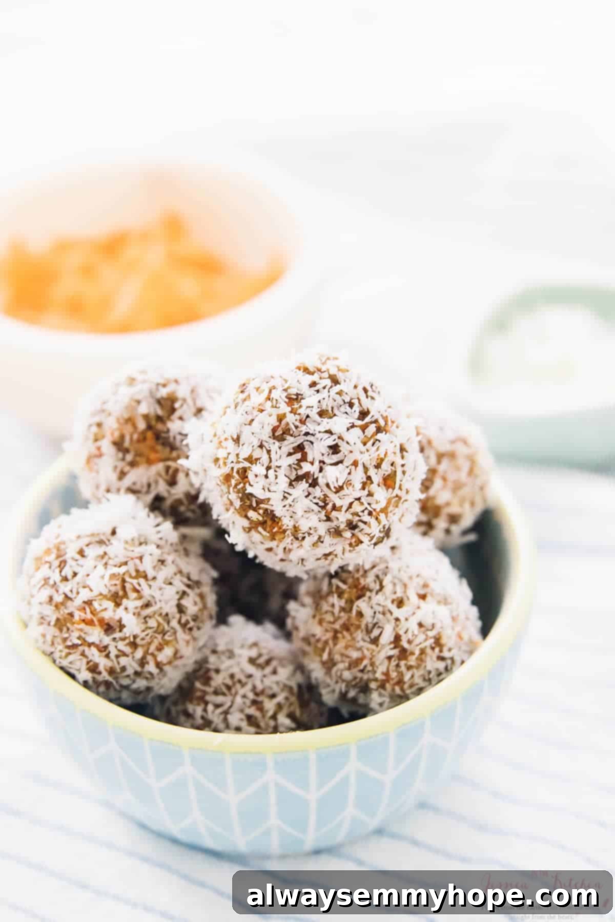 Quick Vegan No Bake Carrot Cake Energy Bites 5 A blue bowl of no bake carrot cake energy bites.