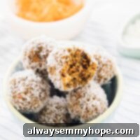 Quick Vegan No Bake Carrot Cake Energy Bites 8 A pile of no bake carrot cake energy bites in a blue bowl.