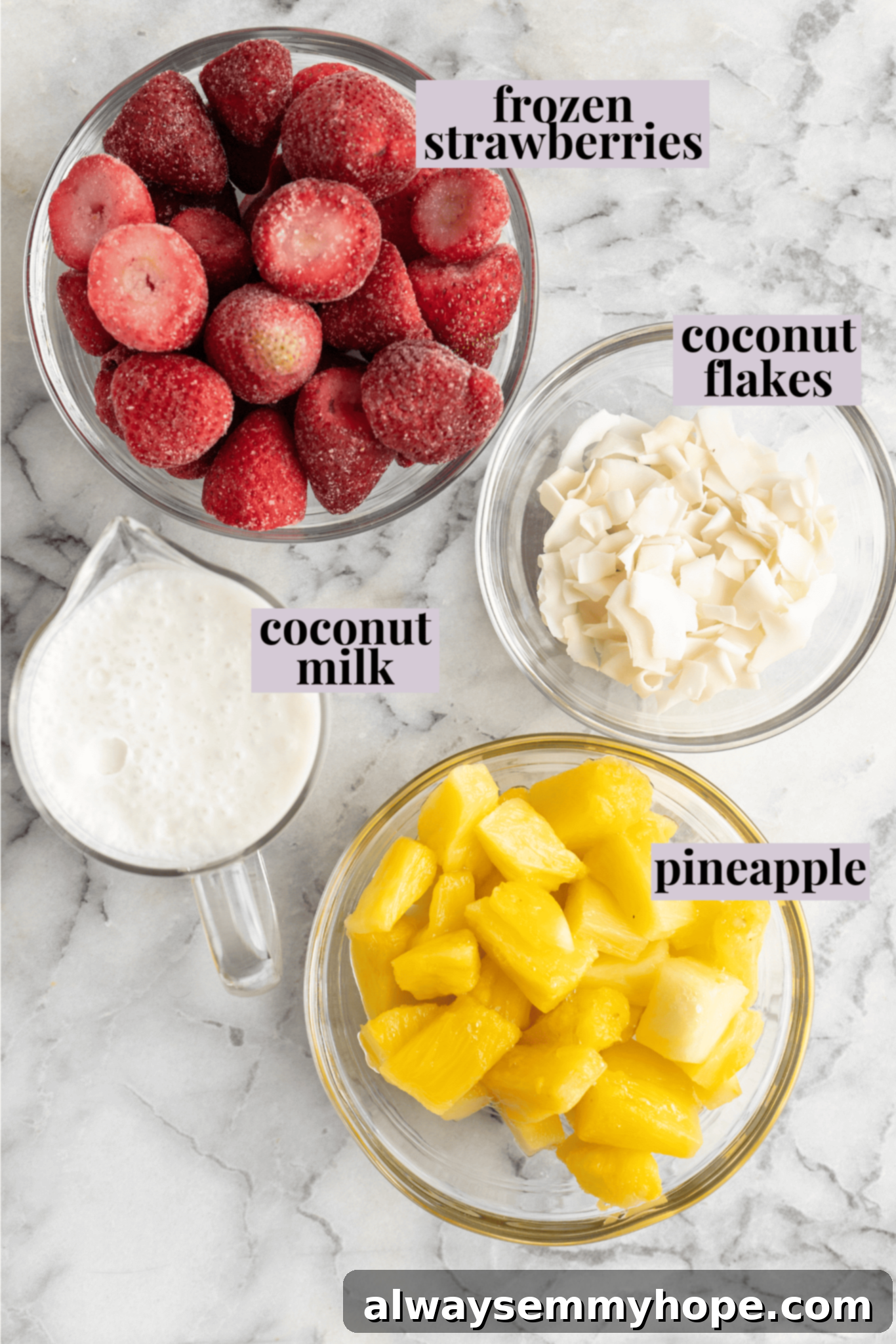 This vegan strawberry pineapple smoothie is light, refreshing, and ready to drink in just 5 minutes. You only need 3 ingredients to make it! Overhead view of fresh ingredients: frozen strawberries, cubed pineapple, and a liquid base like coconut milk, ready for blending into a delicious smoothie.