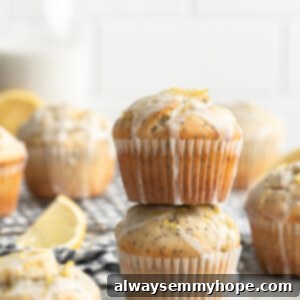 Stack of two vegan lemon poppyseed muffins with a sweet lemon glaze
