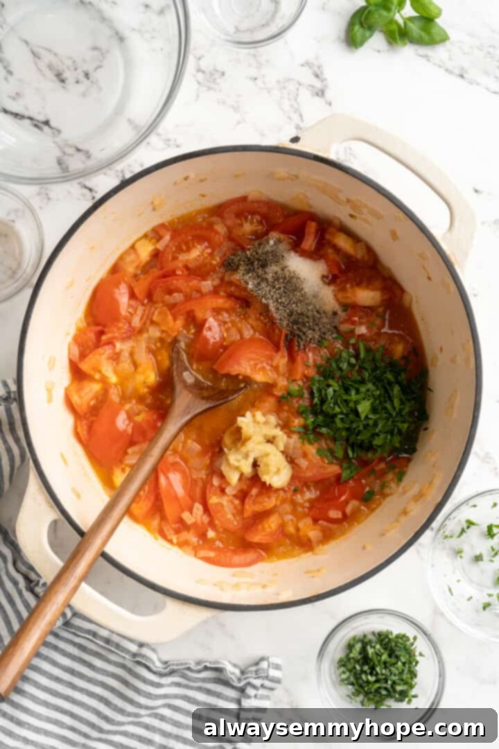 The pot of homemade tomato sauce is seasoned with salt, pepper, and dried oregano, then stirred to combine the aromatic flavors. Stirring seasonings like salt, pepper, and oregano into a pot of simmering tomato sauce