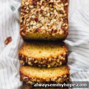 Decadent Gluten-Free Vegan Banana Bread 2 Overhead shot of vegan banana bread cut into slices on a striped cloth.