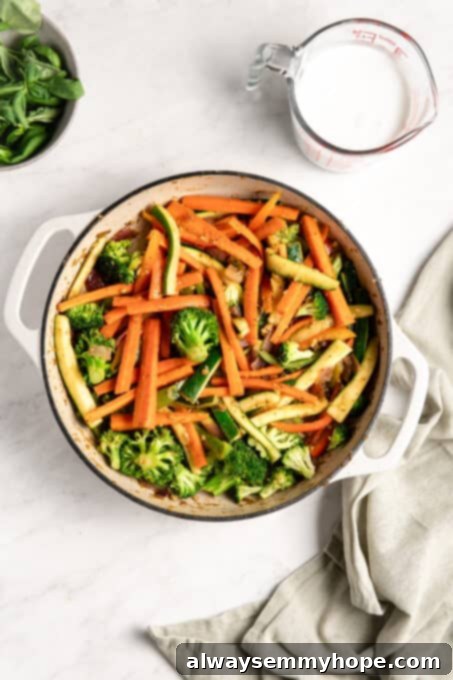 Effortless Thai Green Curry 9 Broccoli, carrots, zucchini, and bell peppers cooking down gently in the pan, absorbing the flavors.