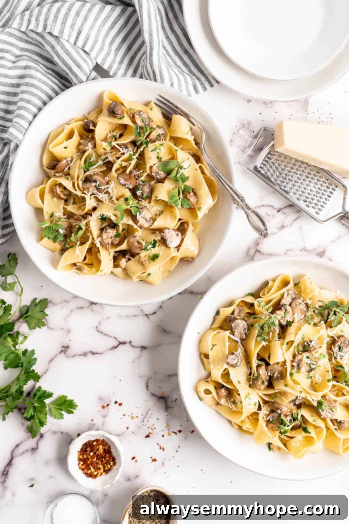 Overhead view of Creamy Garlic Mushroom Pasta in white bowls, beautifully garnished and ready to enjoy.