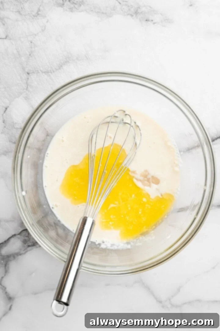 Melted vegan butter and egg replacer added to bowl of vegan buttermilk