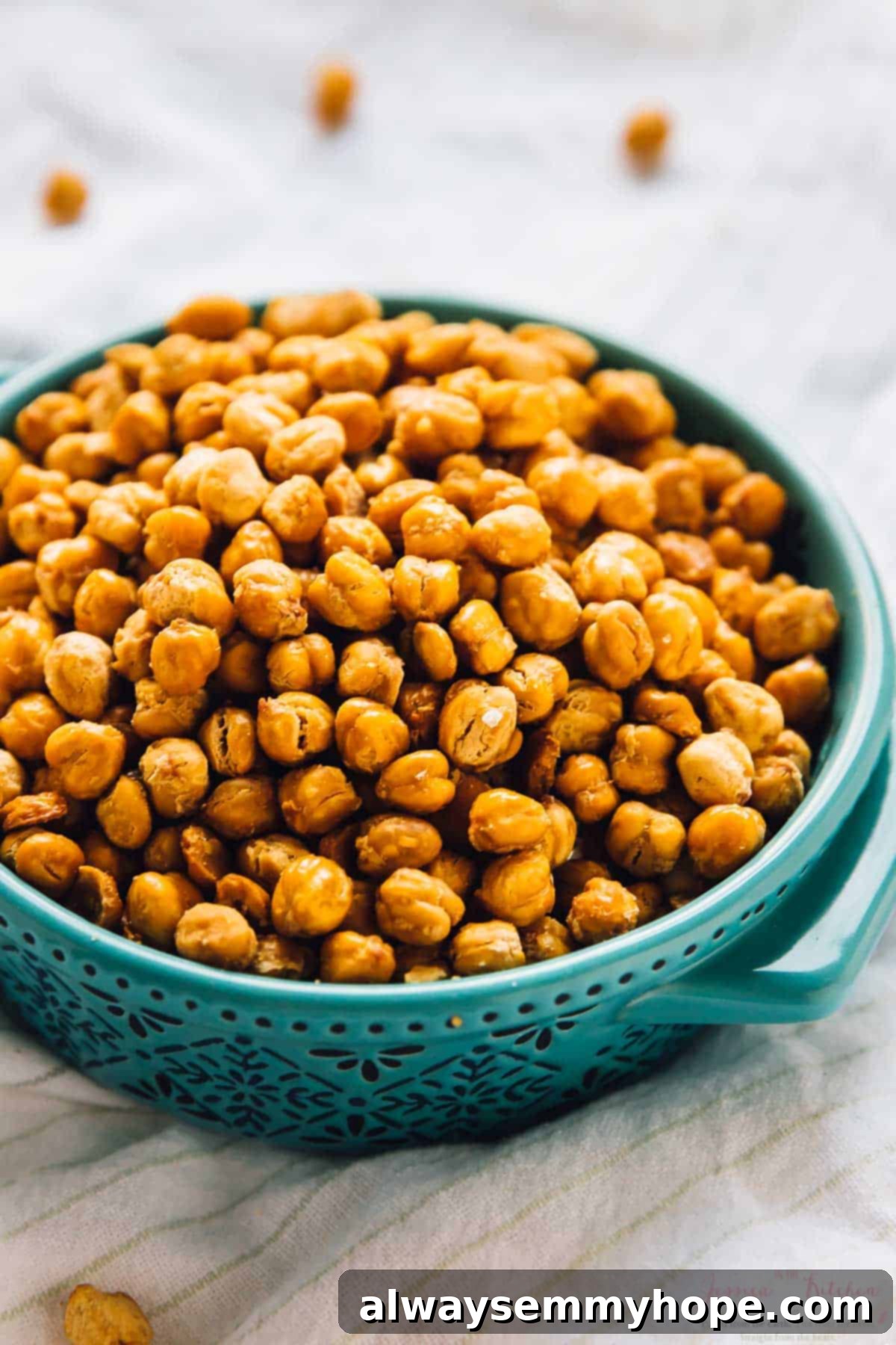 A large, rustic bowl brimming with golden, crispy roasted chickpeas, ready to be served.
