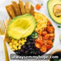 Loaded Taco Salad Bowl with Fresh Lime Crema Drizzle 8 Loaded taco salad bowl with a golden fork on the side.