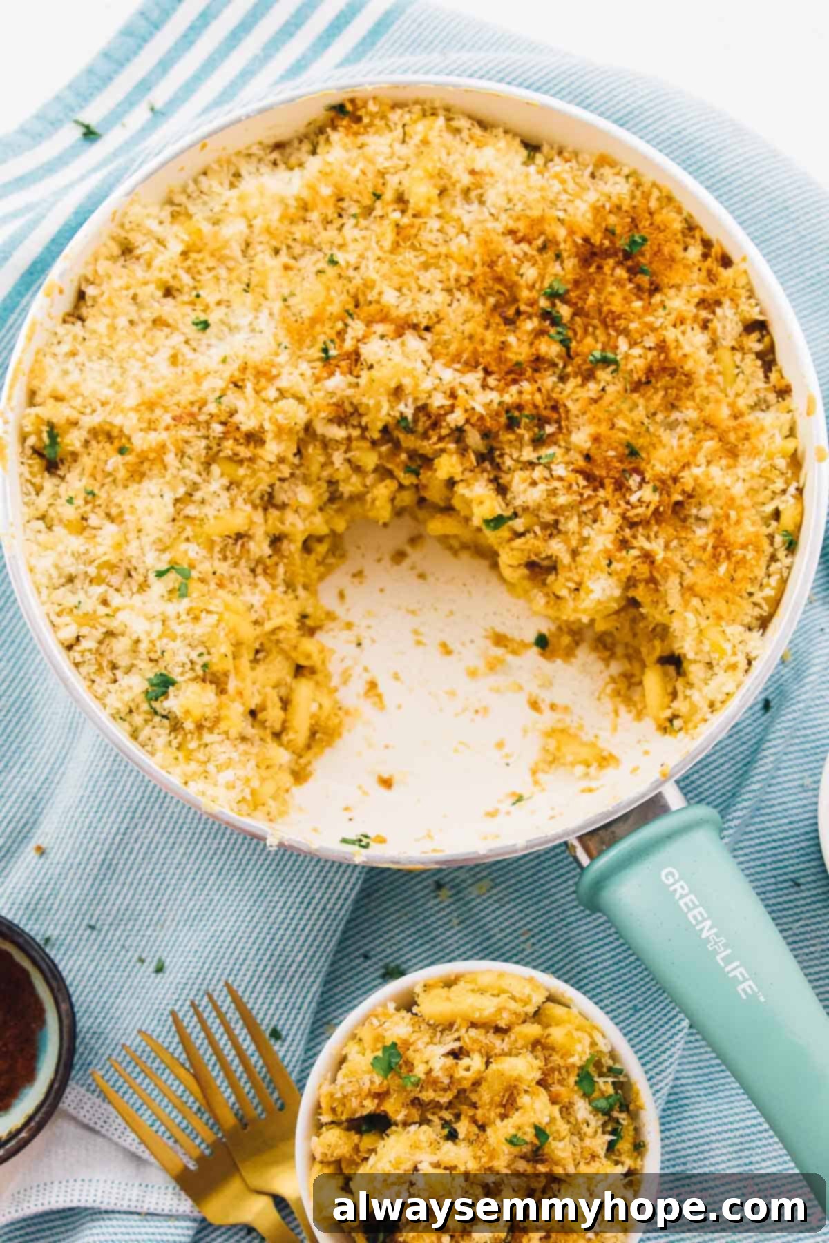 Top down view of mac and cheese in a skillet with a portion taken out. 