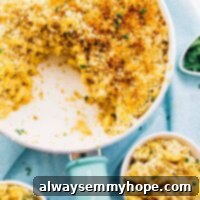 Top down view of creamy baked vegan mac & cheese in a skillet with a blue handle.