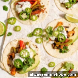 Sizzling Plant-Based Fajitas 2 Vegan fajitas with jalapeno slices and lime wedges.