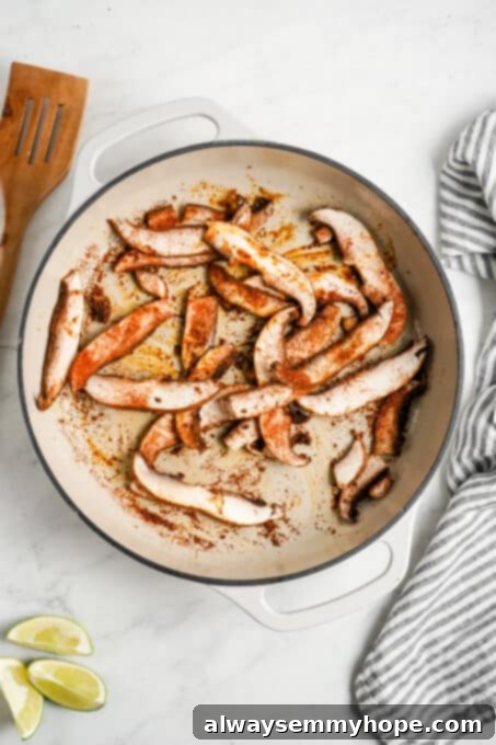 Meaty portobello mushrooms make the best vegan fajitas, sautéed with tender bell peppers and homemade fajita seasoning. Ready in 30 minutes! Portobello mushrooms cooking in a pan.