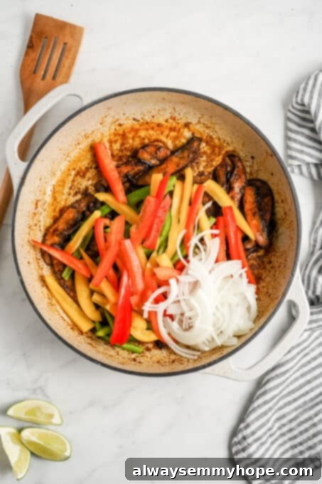 Meaty portobello mushrooms make the best vegan fajitas, sautéed with tender bell peppers and homemade fajita seasoning. Ready in 30 minutes! Bell pepper, onion, and portobello mushrooms in a pan.