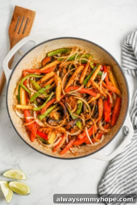 Meaty portobello mushrooms make the best vegan fajitas, sautéed with tender bell peppers and homemade fajita seasoning. Ready in 30 minutes! Mushrooms, pepper, and onion cooking in a skillet.