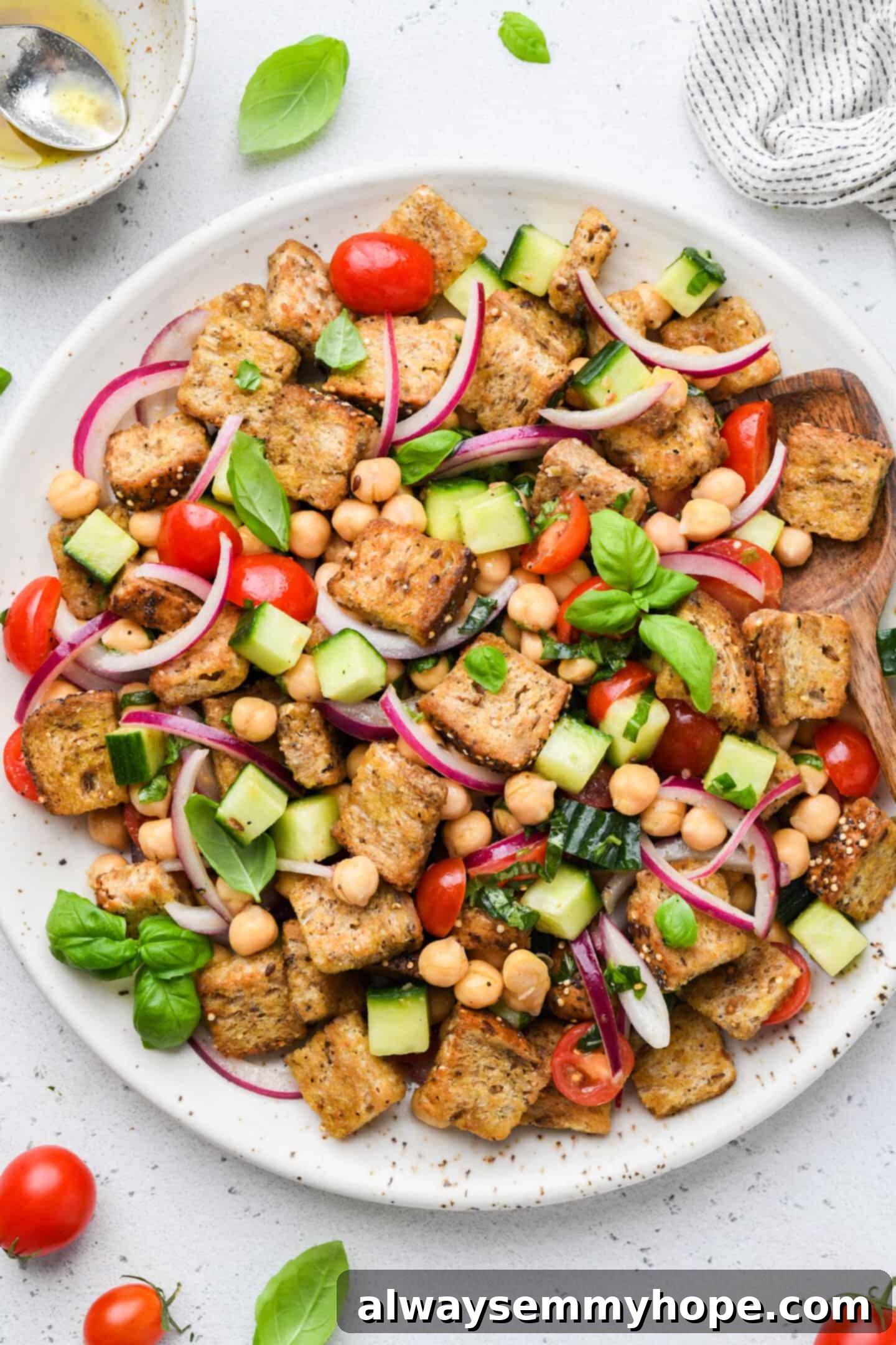 Rustic Chickpea Panzanella 2 Overhead view of chickpea panzanella salad on white serving platter