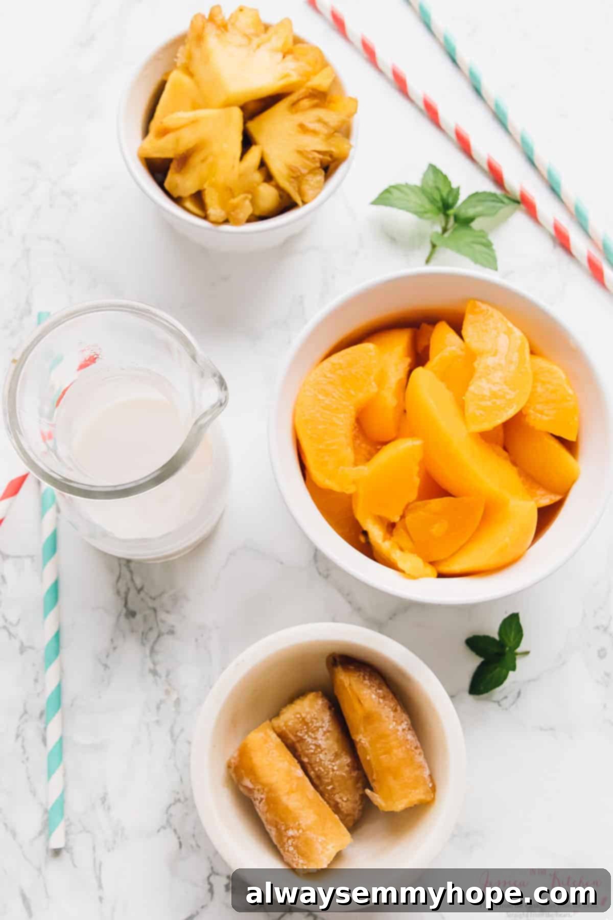 Sunshine Pineapple Peach Smoothie 3 An overhead shot showcasing the fresh ingredients laid out for a pineapple peach smoothie: frozen peach slices, fresh pineapple chunks, a ripe frozen banana, and a carton of Silk Protein Nutmilk.