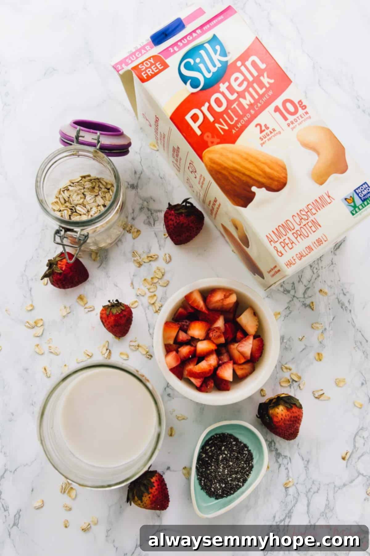 These sweet coconut strawberry overnight oats are the easiest breakfast ever! Just 5 minutes of prep for a tasty grab-and-go breakfast. Overhead view of ingredients for strawberry coconut overnight oats.
