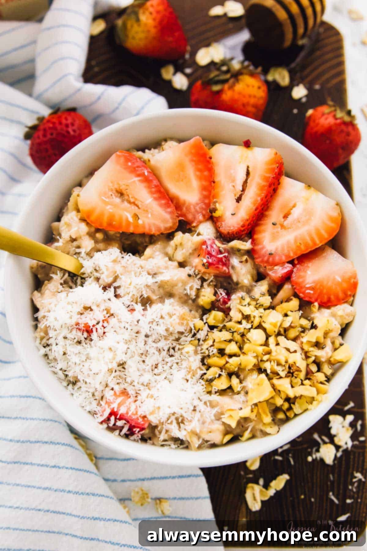 These sweet coconut strawberry overnight oats are the easiest breakfast ever! Just 5 minutes of prep for a tasty grab-and-go breakfast. Bowl of strawberry coconut overnight oats garnished with coconut and sliced strawberries.