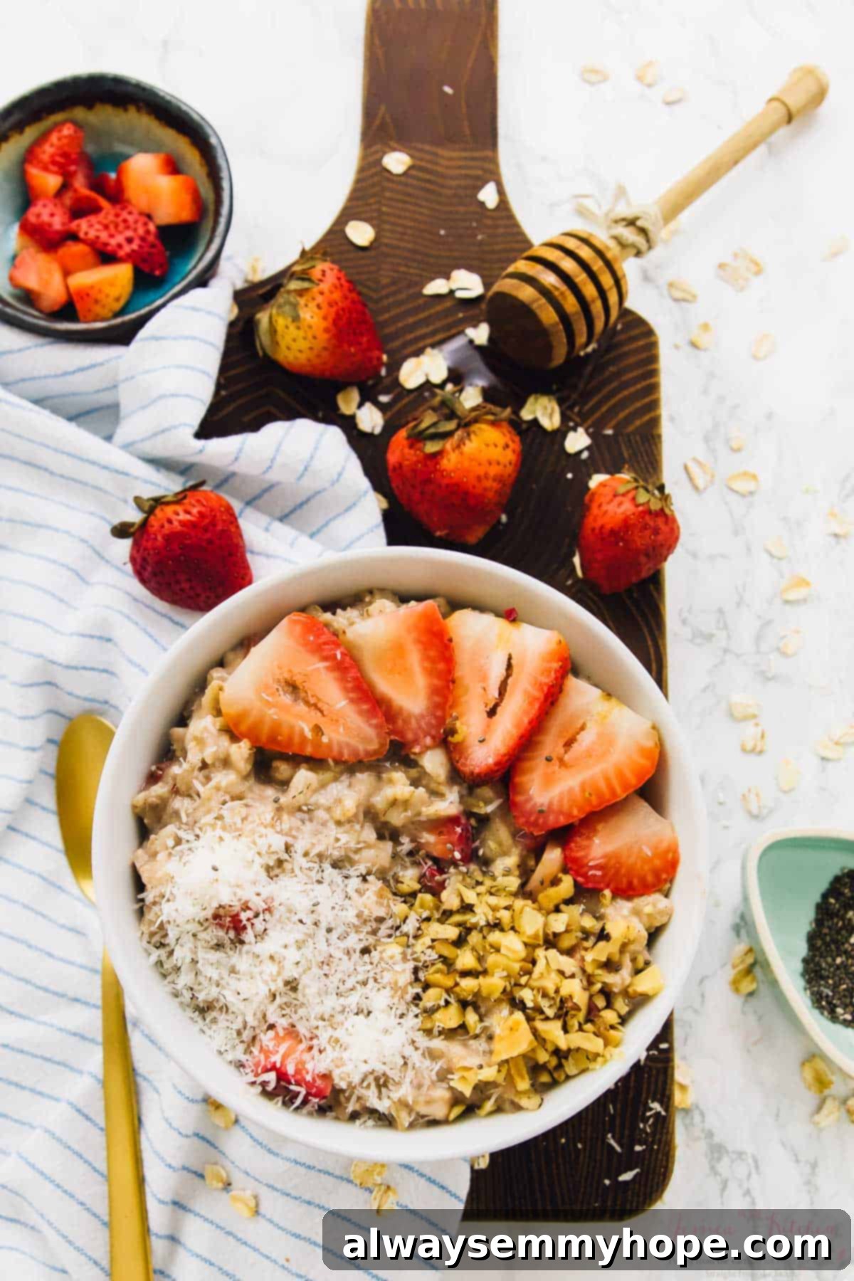 These sweet coconut strawberry overnight oats are the easiest breakfast ever! Just 5 minutes of prep for a tasty grab-and-go breakfast. Bowl of strawberry coconut overnight oats on wood board.