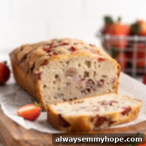 Loaf of strawberry banana bread with one slice cut